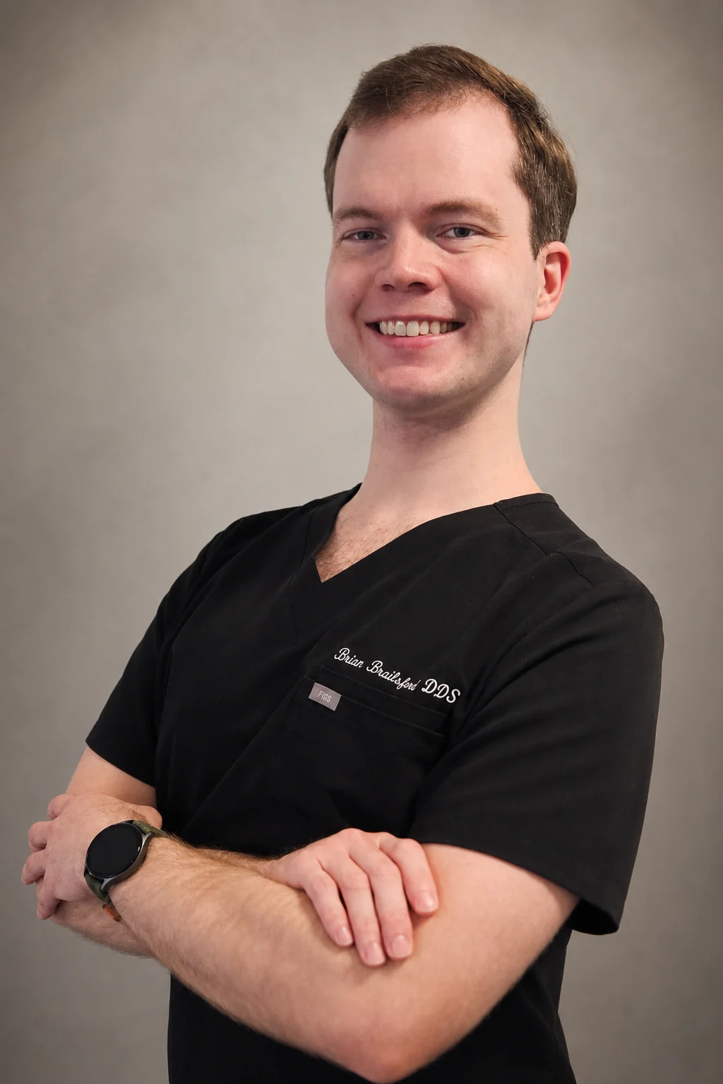 Dr. Brian Brailsford wearing black clinical scrubs